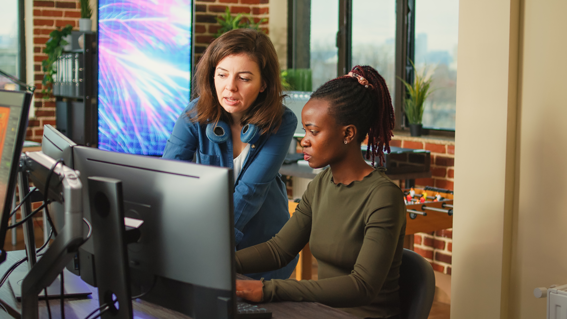 Team working on a computer using latest technology.