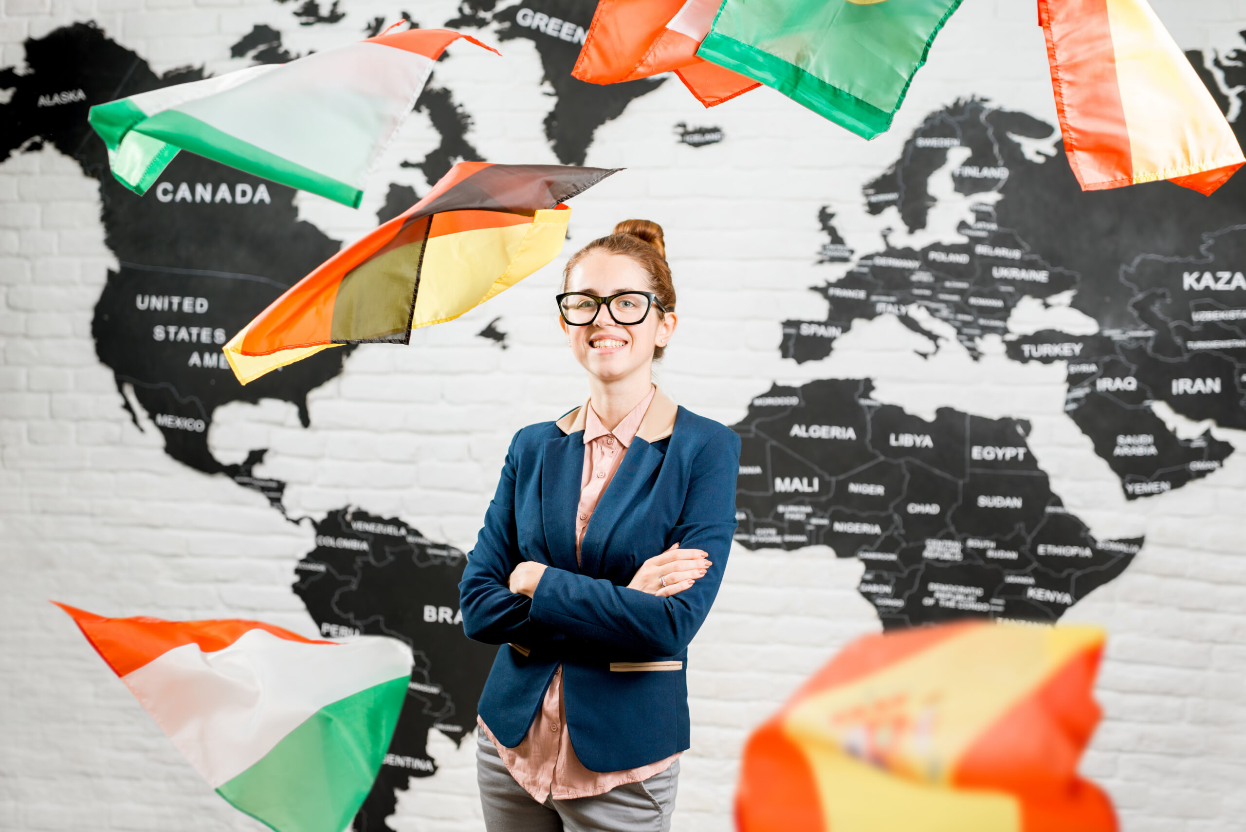 a woman standing in front of a world map